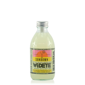 Sundown hand wash. Clear hand wash in a clear glass bottle, with a pink and yellow label and an aluminium top.